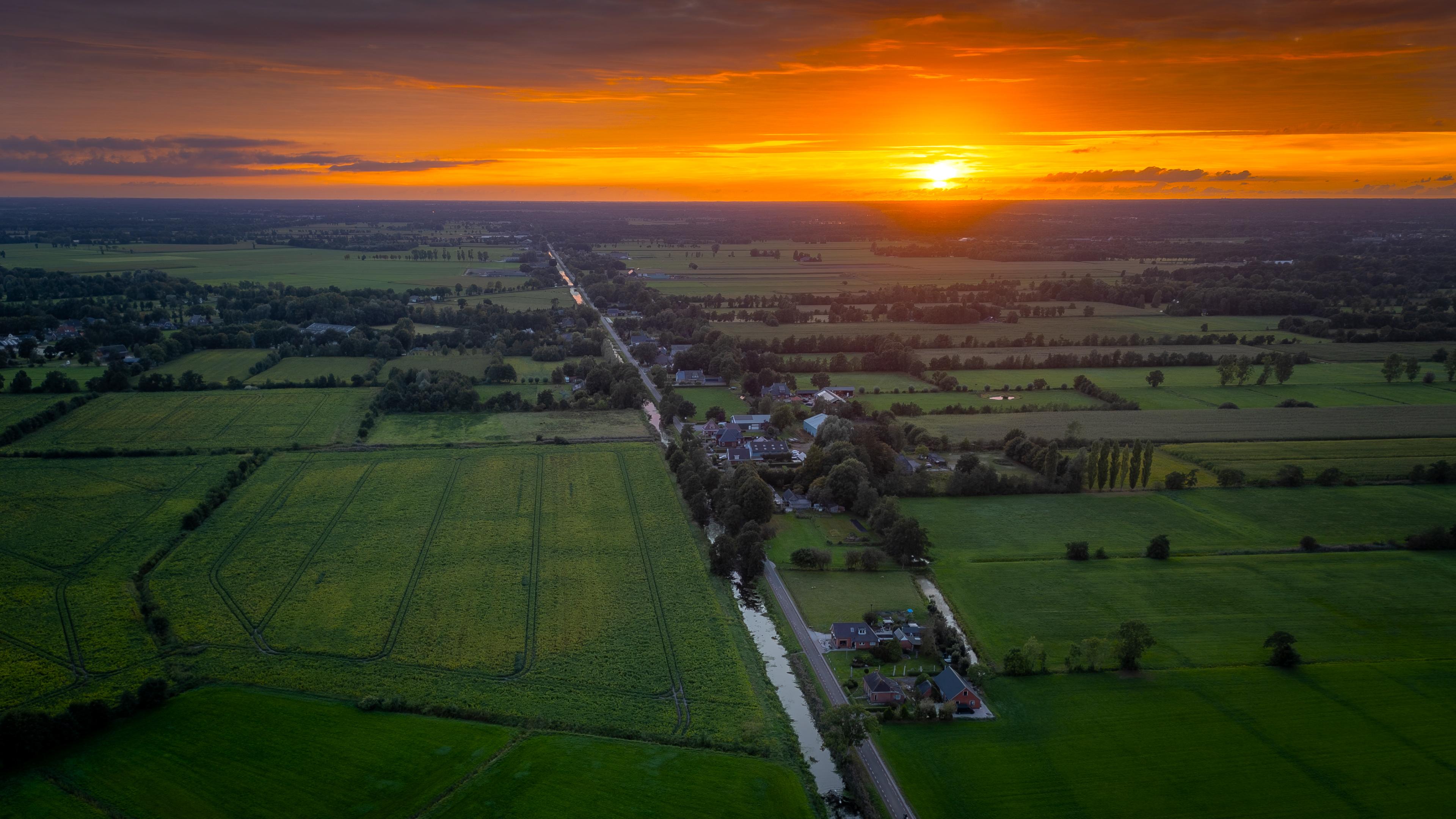 Golden Sunset Over Green Farmland - 4K Background Golden Sunset Over Green Farmland - Aerial Photography 4K Wallpaper (3840x2160)