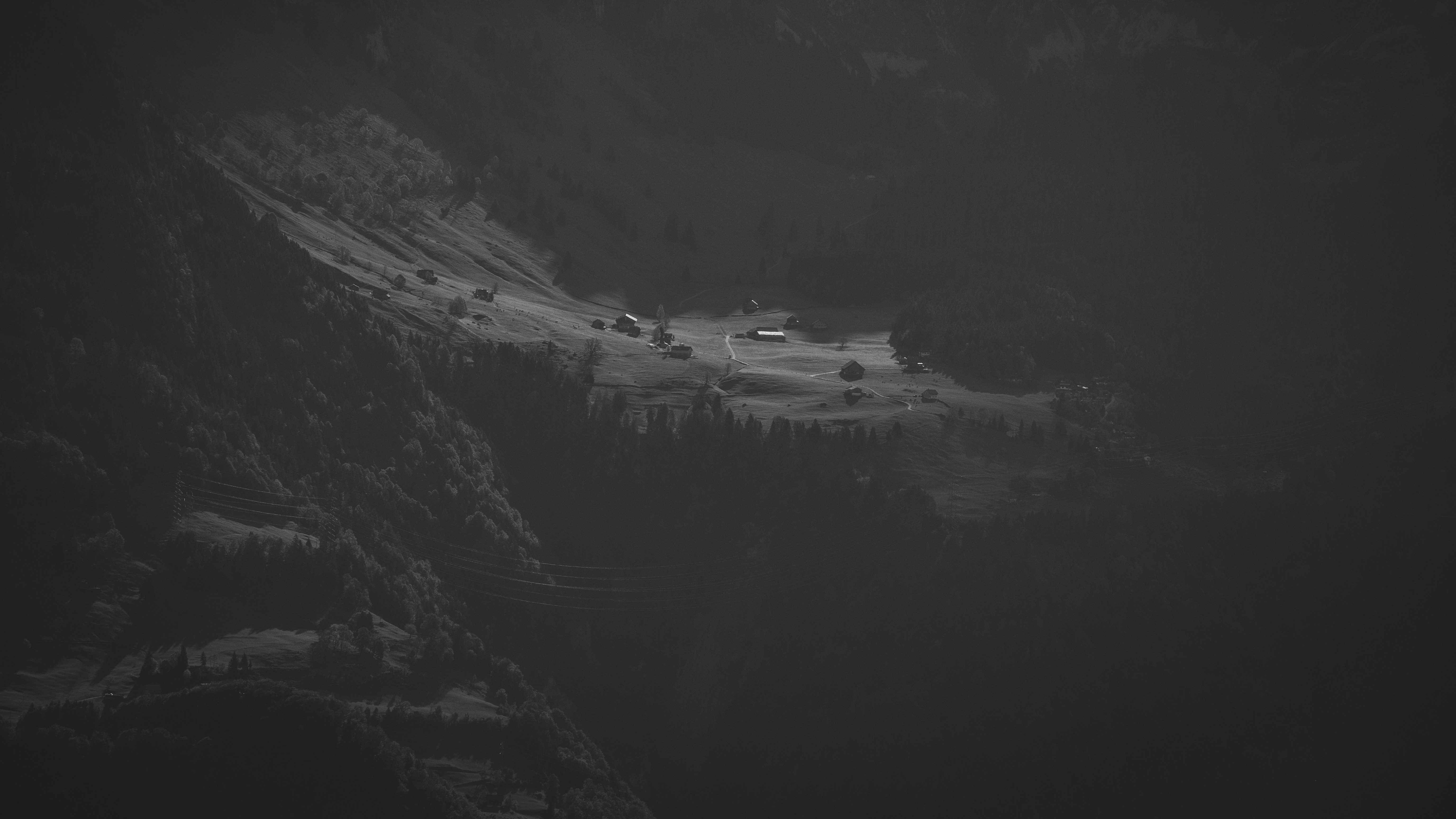 Illuminated Alpine Village In Shadow - 5K Background Illuminated Alpine Village In Shadow - Dramatic Monochrome Photography 5K Wallpaper (6144x3457)