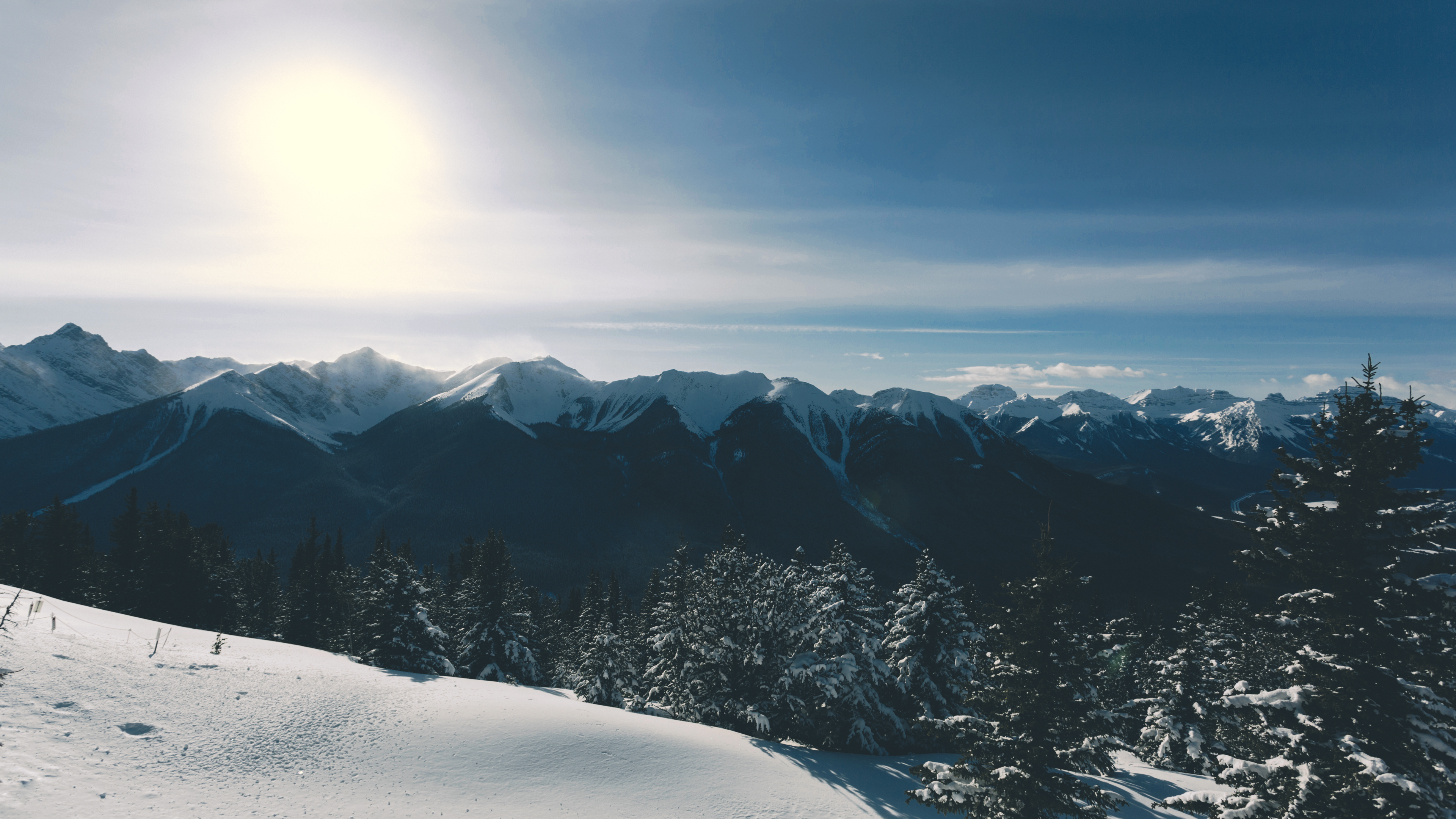 Snowy Mountain Vista Under Bright Sun - 4K Background Snowy Mountain Vista Under Bright Sun - Winter Landscape Photography 4K Wallpaper (3840x2160)