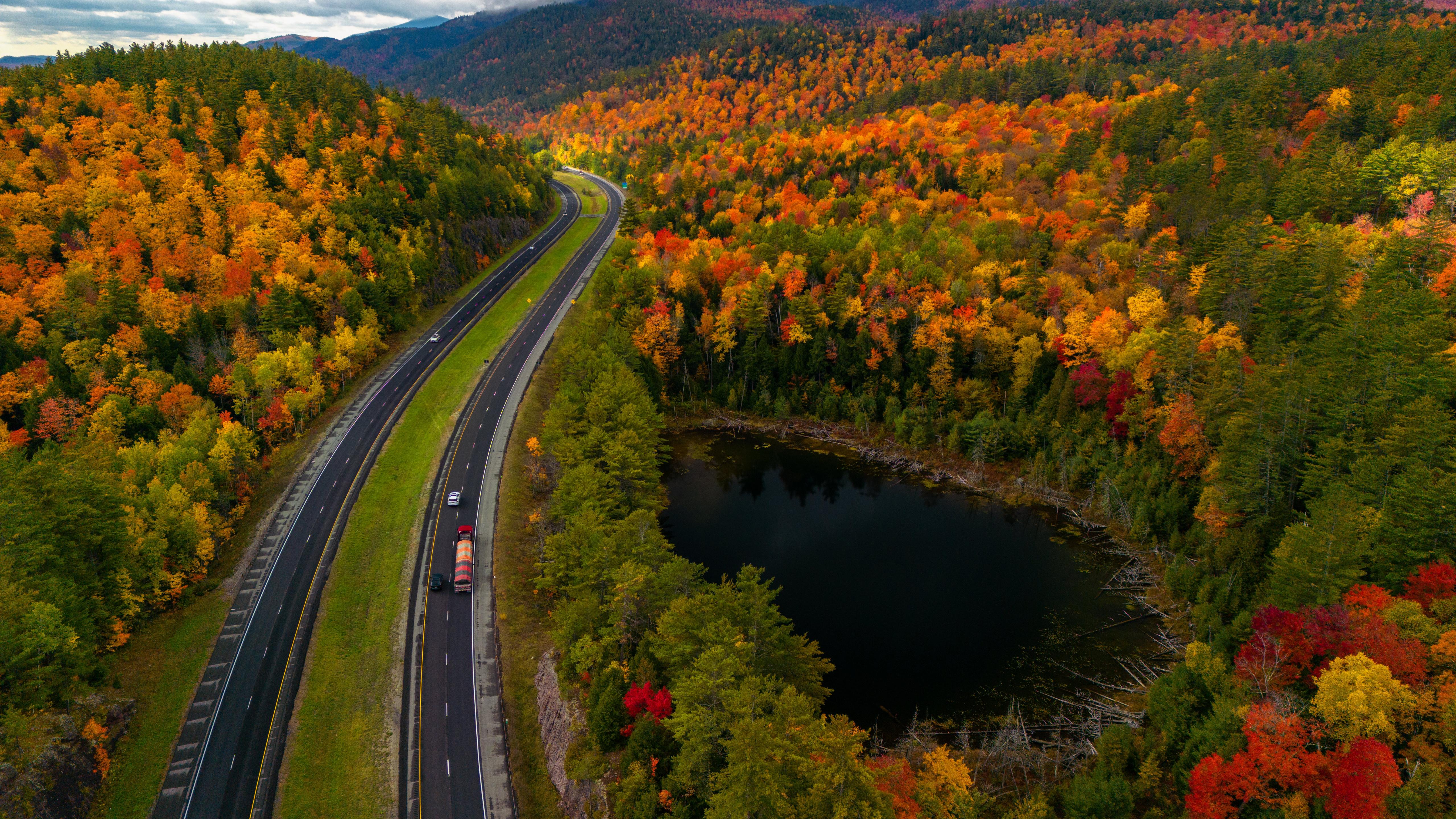 Winding Highway Through Autumn Forest - 5K Background Winding Highway Through Autumn Forest - Aerial Landscape Photography 5K Wallpaper (5120x2880)
